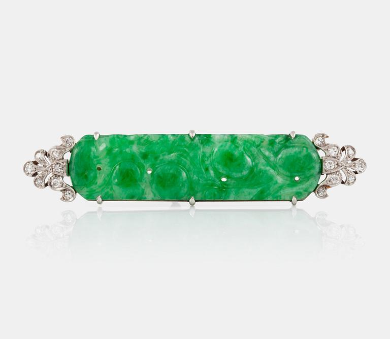 A carved jade and diamond brooch.