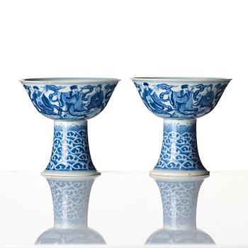 A pair of blue and white 'eight immortals' stemcups, Qing dynasty with Daoguang mark and of the period.