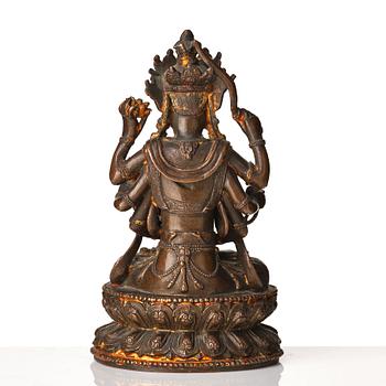 A cold gilt copper alloy figure of eight armed Boddhisattva Avalokiteshvara, late Ming dynasty.