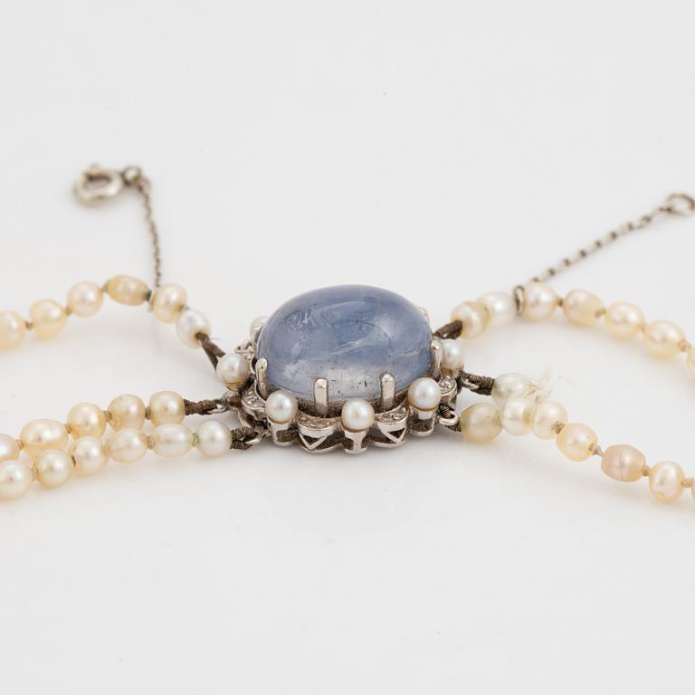 Three strand pearl necklace, clasp with cabochon cut sapphire.