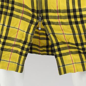 A checkered skirtby Jean Paul Gaultier.