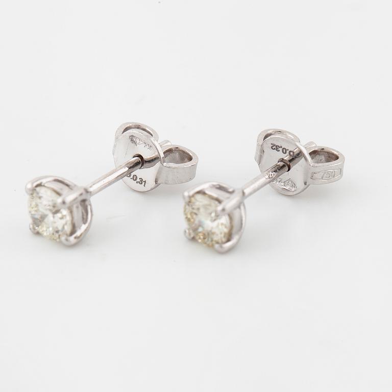 A pair of brilliant cut diamond earrings.