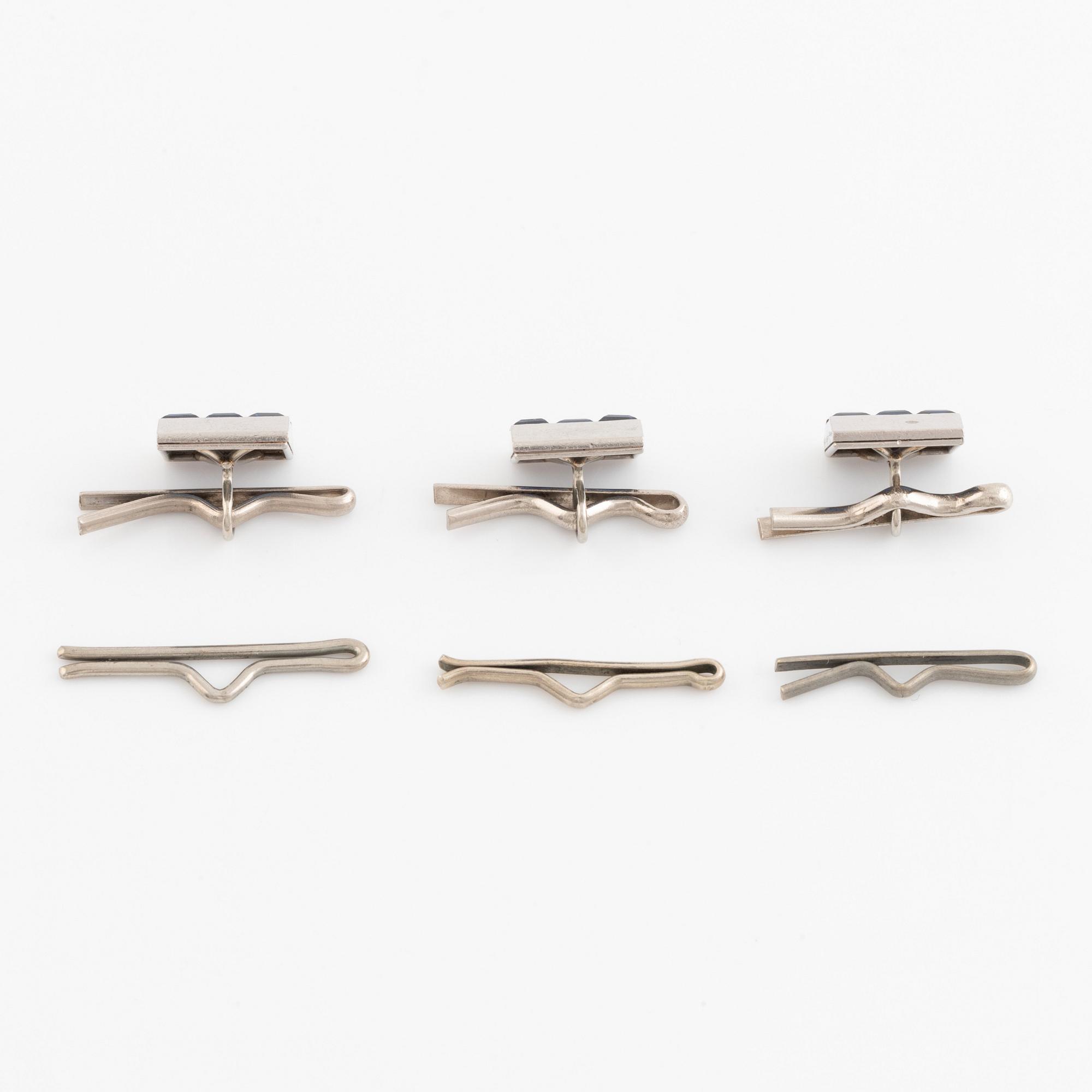 Boucheron, three shirt buttons, platinum and step cut sapphires.