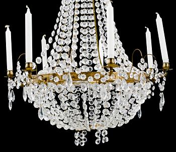 A 20th century chandelier in the Empire style. Height ca 96 cm.