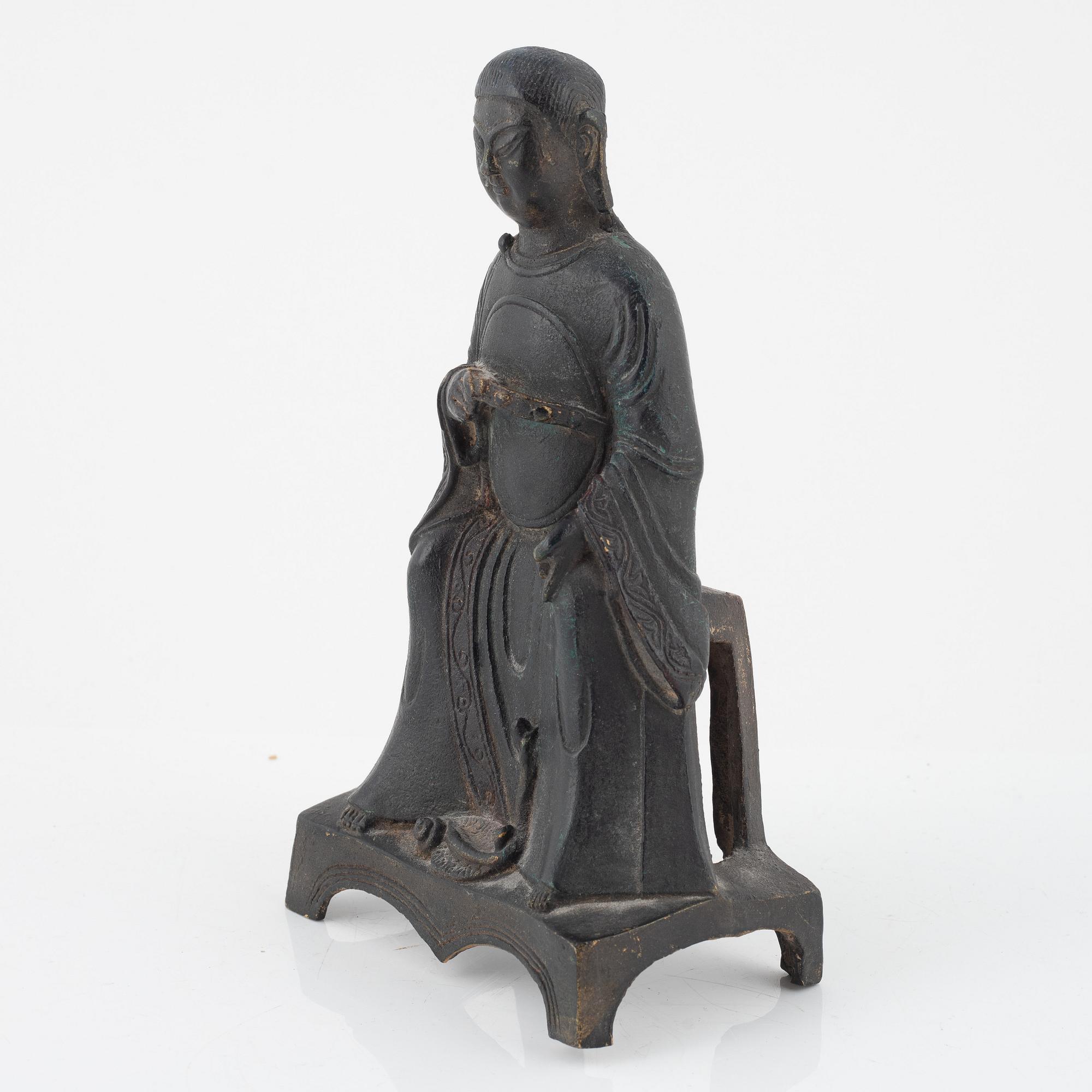A bronze sculpture of a seated deity, Ming style, probably 20th Century.