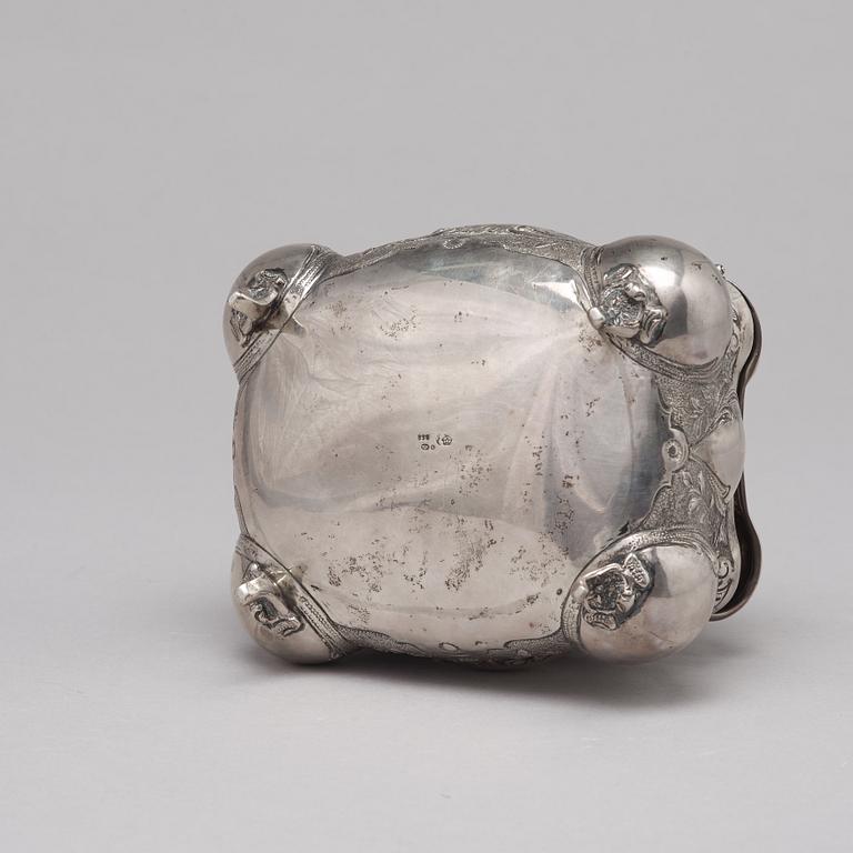 A silver sugar box.