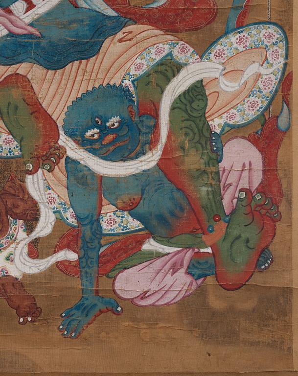 A Tibetan Thangka colour and ink on cloth laid on paper, 19th Century.