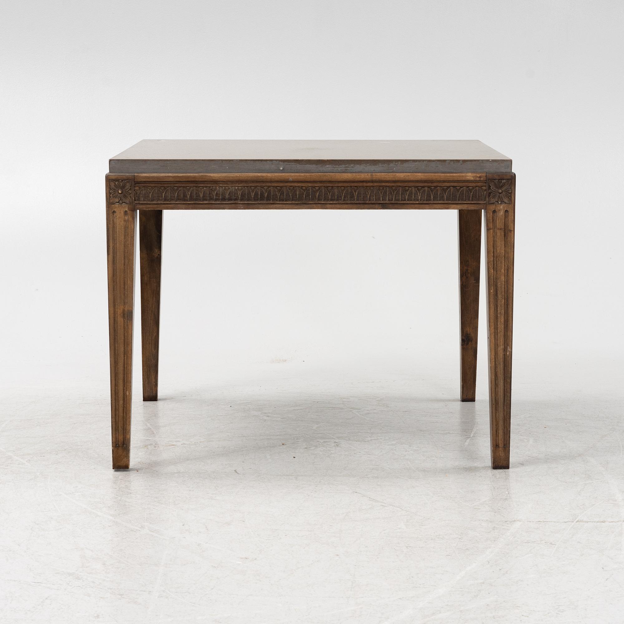 A Louis XVI style coffee table with a limestone top.