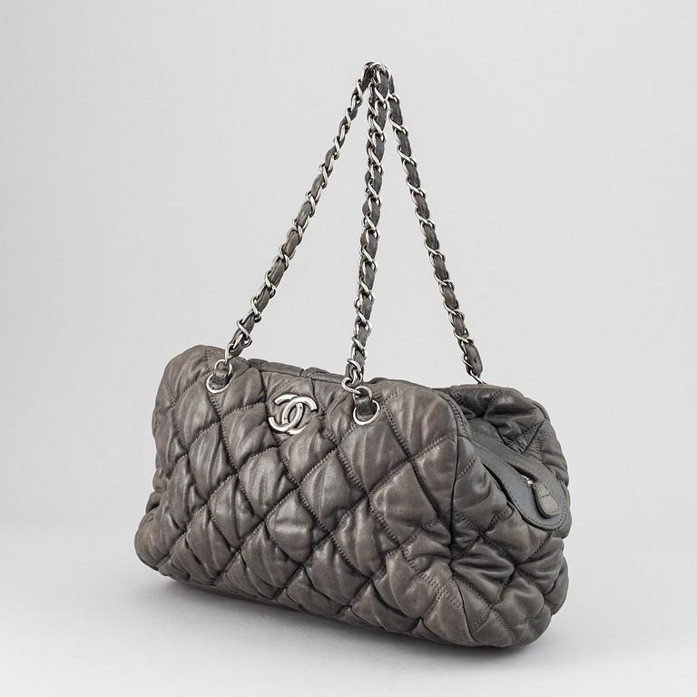 Chanel, a grey leather bag.