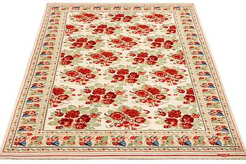 A carpet with a rose pattern, c. 310 x 196 cm.
