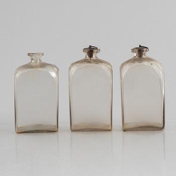 A wooden box with three glass flaska, first half of the 19th century.