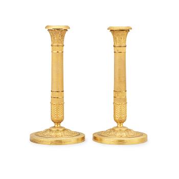 1622. A pair of Empire candlesticks.