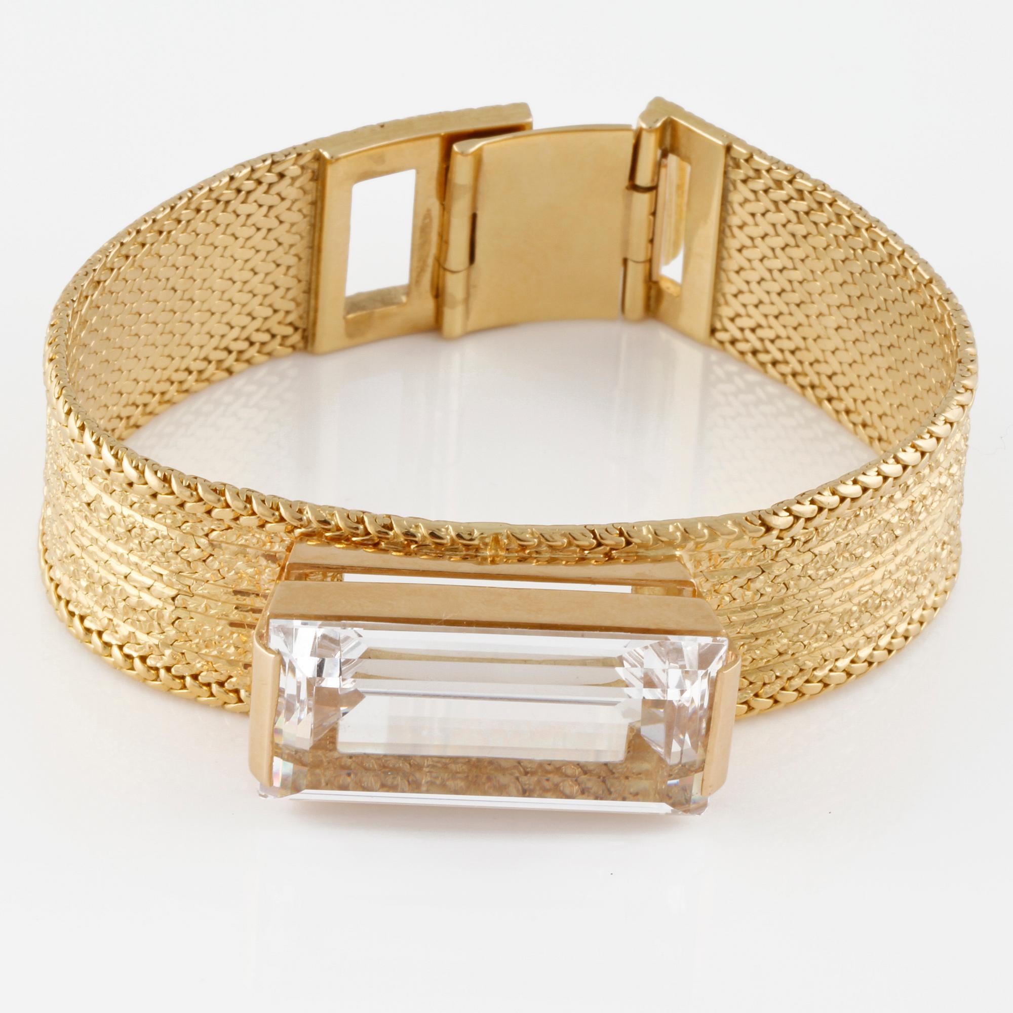 ARMLÄNK, 18K guld med fasettslipad vit syntetisk spinell, importstämplad. Vikt 68,9 gram.