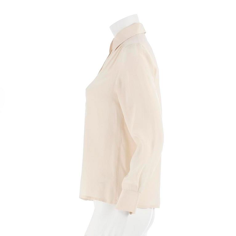 CÉLINE, a créme colored silk blouse, size 40.
