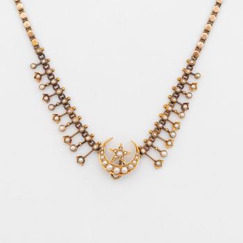 A gold necklace set with pearls.