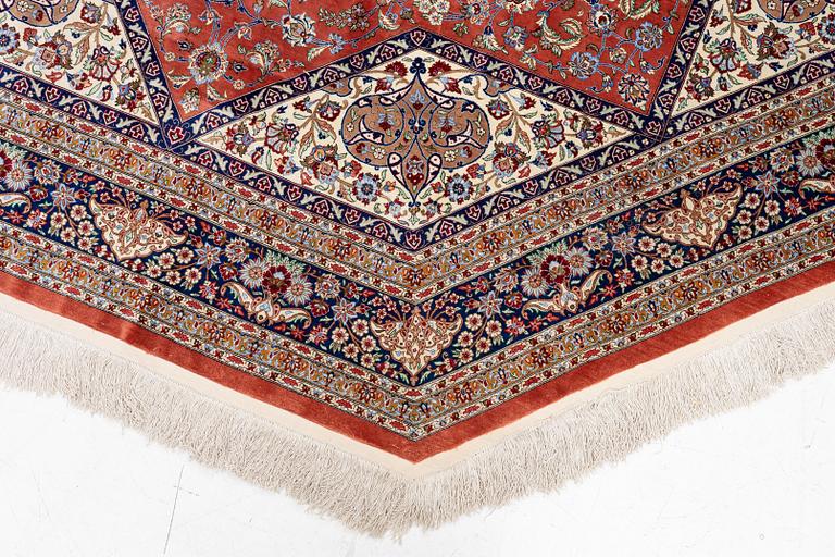 An Oktagonal  silk Qum rug, Central Persia, signed, c. 250 x 250 cm.