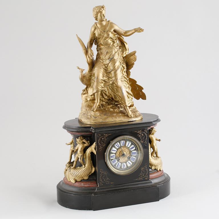 A TABLE CLOCK in stone and painted metal from the beginning of the 20th century.