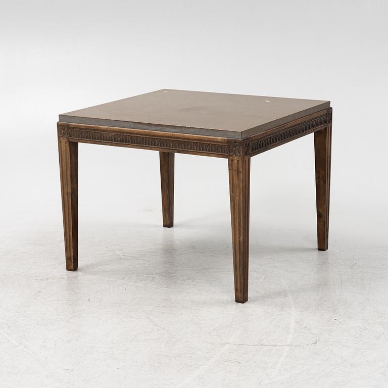 A Louis XVI style coffee table with a limestone top.