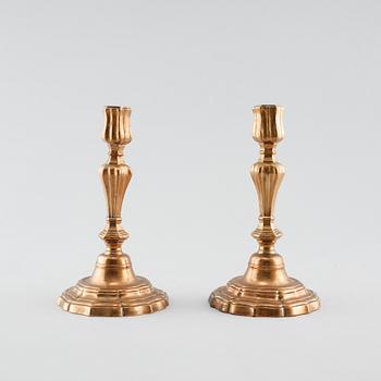 A pair of late barouqe bronze candlesticks, 18th century.