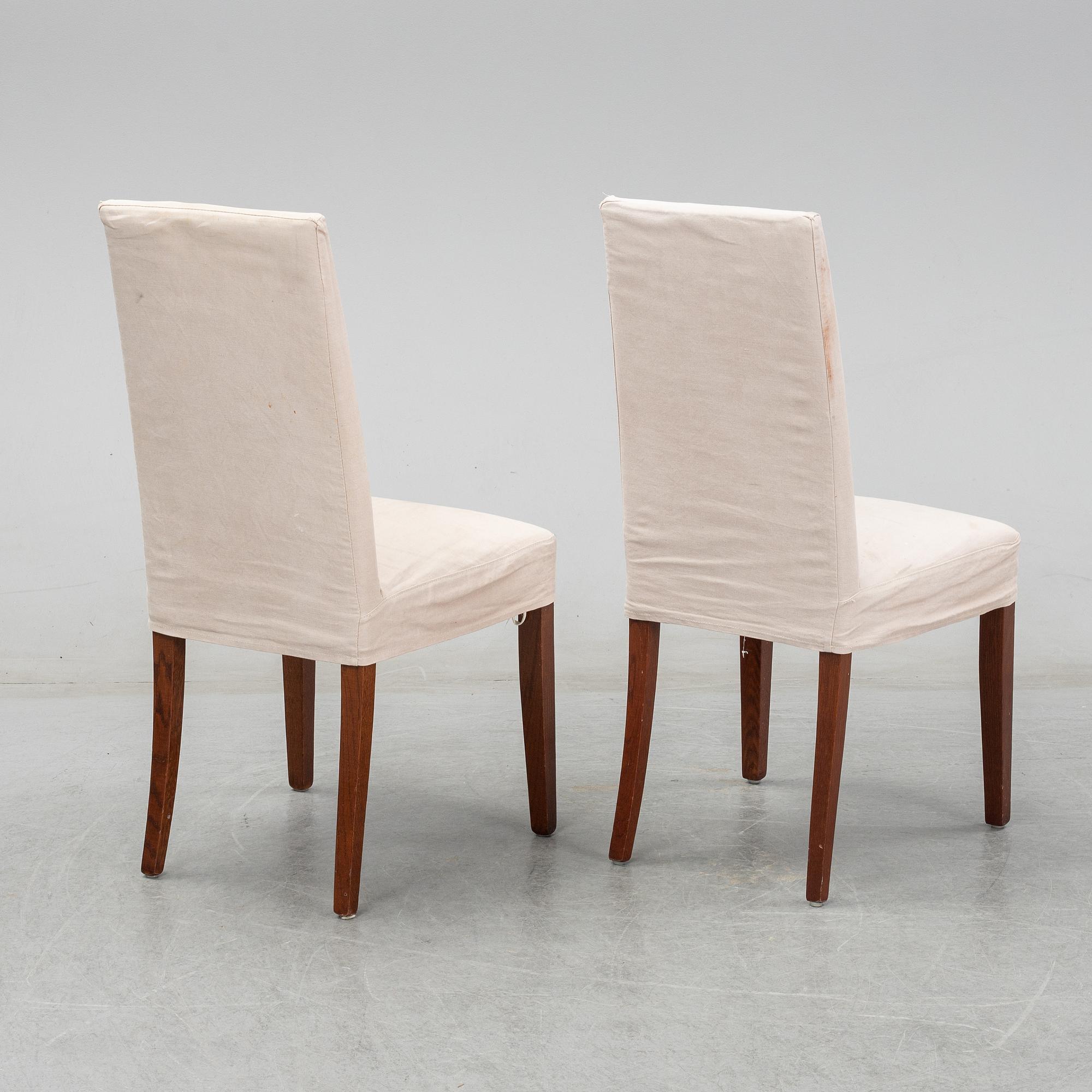 An stained oak dining table with eight chairs.