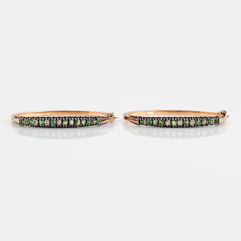 A pair of 14K gold and silver bangles set with demantoid garnets and old-cut diamonds.