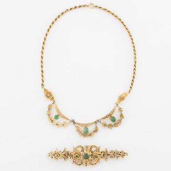 Necklace and bracelet in with floral motif set with cabochon-cut emeralds and rose-cut diamonds.
