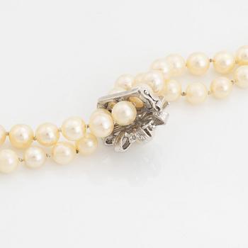 A cultured pearl necklace with silver divider.