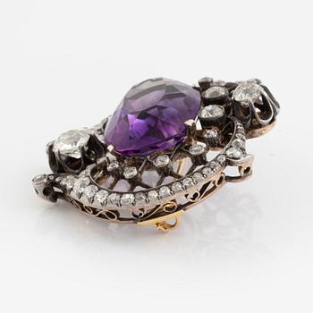 A brooch set with an amethyst and old-cut diamonds.