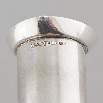 Two silver drink accessories with finnish stamps.