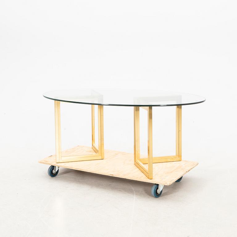 A glass and metal coffee table from the first half of the 20th century.