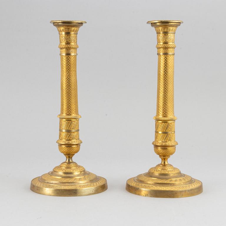 An early 19th Century pair of bronze empire candle sticks.