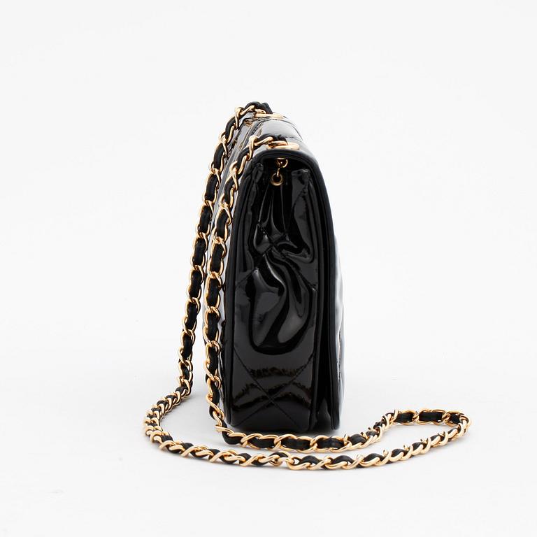 CHANEL, a black patent leather shoulder back.