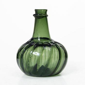 A green twisted glass bottle, 18th century.