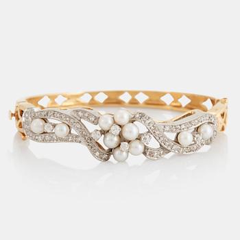 863. A 14K gold bangle set with old- and eight-cut diamonds and pearls.