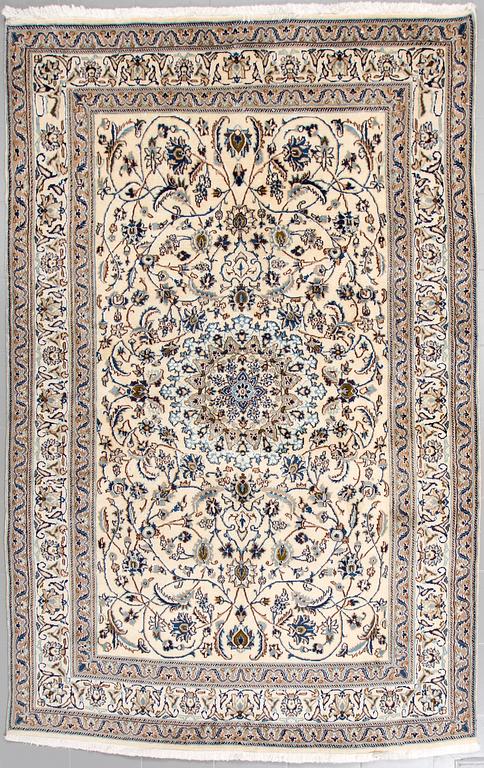 A Nain rug, part silk, 296 x187 cm.