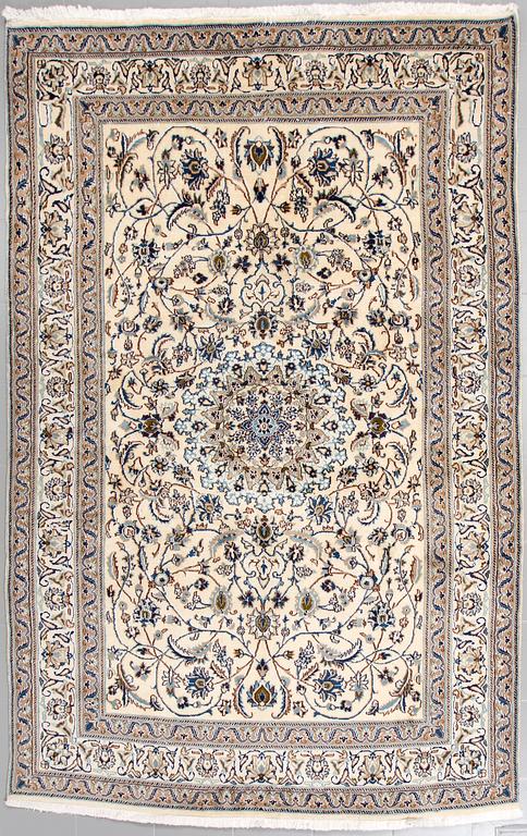 A Nain rug, part silk, 296 x187 cm.