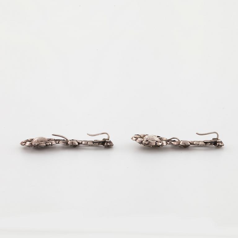 A pair of earrings and a brooch set with rose cut diamonds.