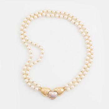 A two strand cultured pearl necklace with an 18K gold clasp with a half-pearl and round brilliant-cut diamonds.