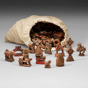 A bag with about 270 chess pieces, carved and painted wood. Mongolia, 19th Century or older.