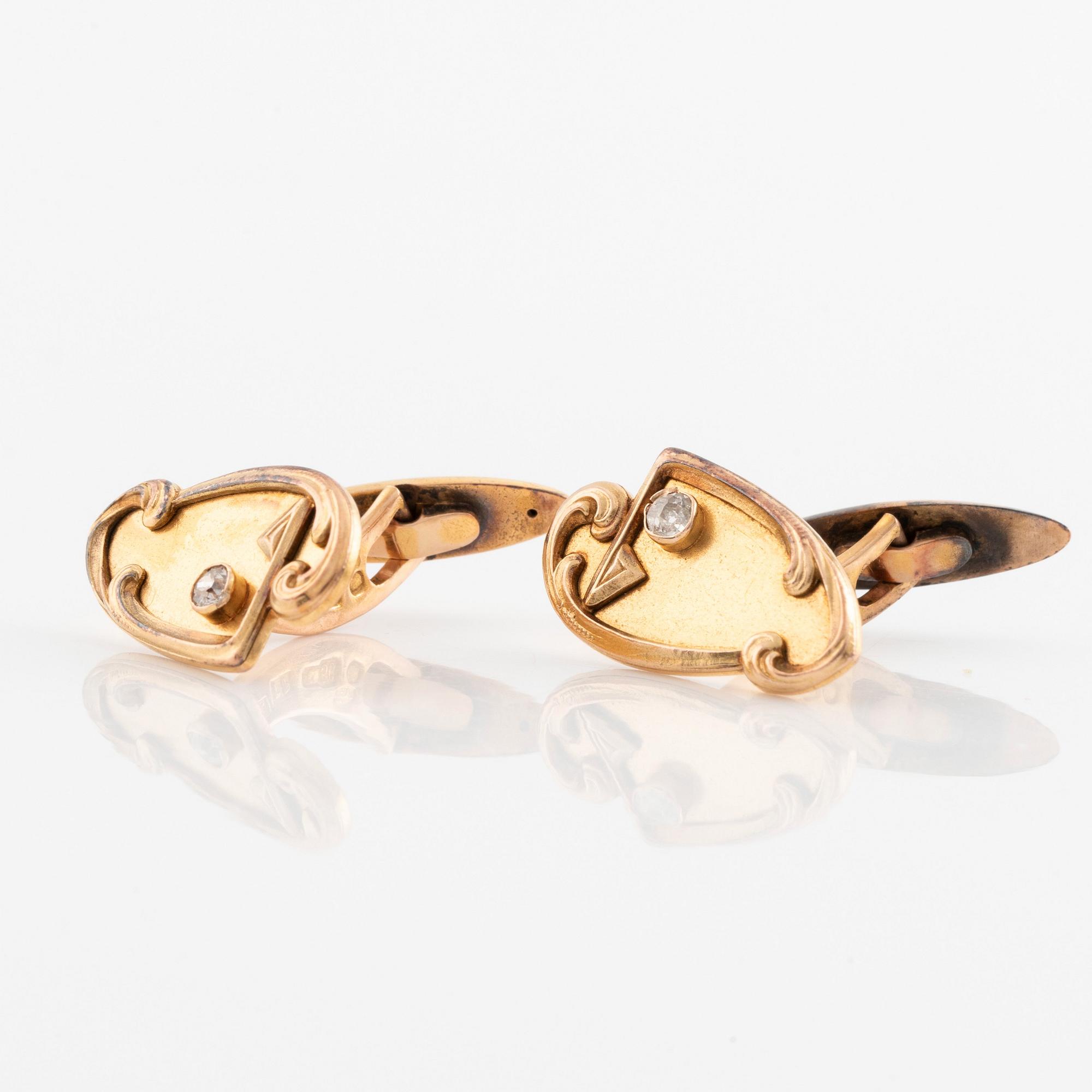 A pair of 14K gold cufflinks set with old-cut diamonds.