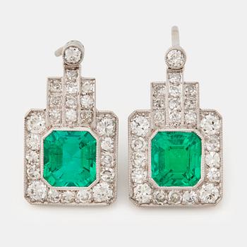 838. A pair of 1940/50's emerald cut emeralds and brilliant- and single cut diamond earrings.