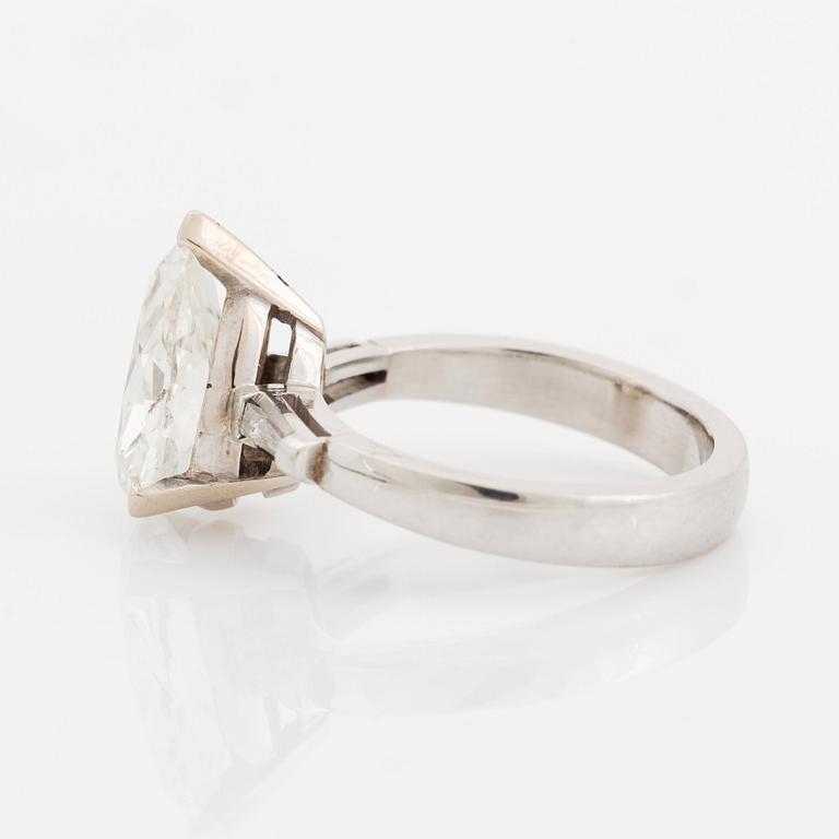 A platinum ring set with a pear shaped old-cut diamond weight ca 3.00 cts quality ca I si2.