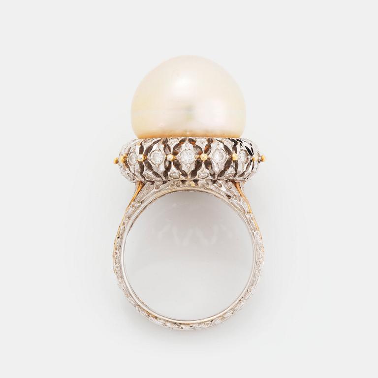 An 18K gold ring set with a cultured pearl and round brilliant-cut diamonds.