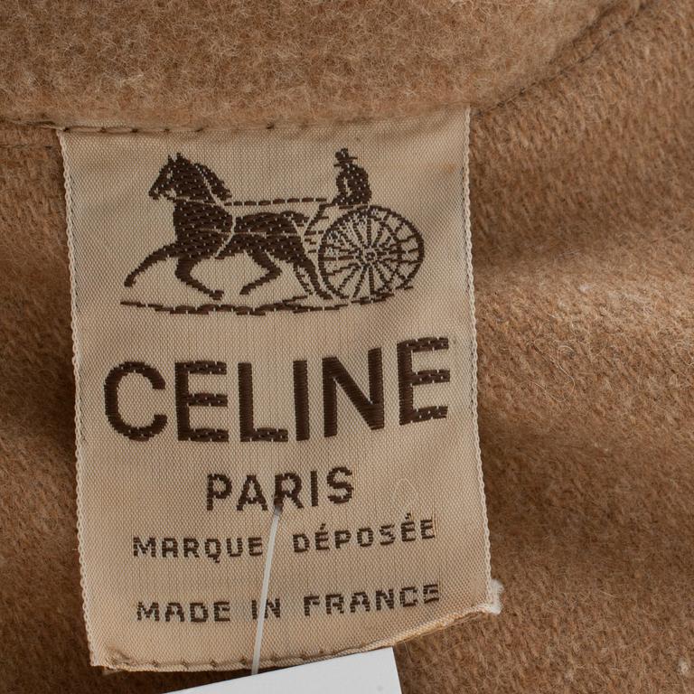 CÉLINE, a beige wool blend cape.