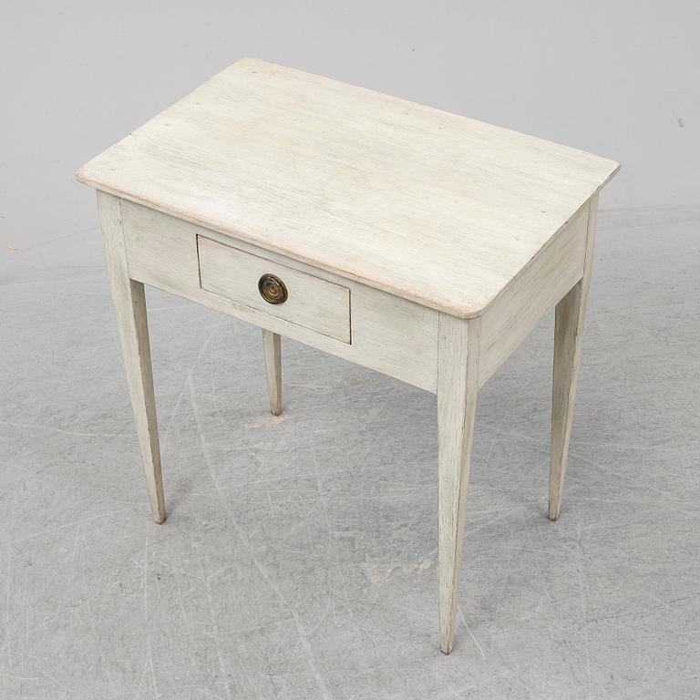 An early 19th Century painted table with a drawer.