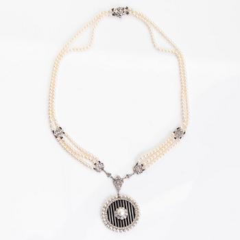 An 18K white gold necklace with cultured pearls, enamel and brilliant-cut diamonds. England.