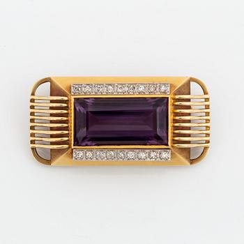 A 14K gold brooch set with a faceted amethyst and eight-cut diamonds.