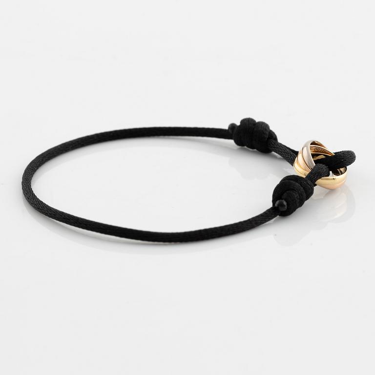 A Cartier "Trinity" bracelet, 18K three colour gold and textile.