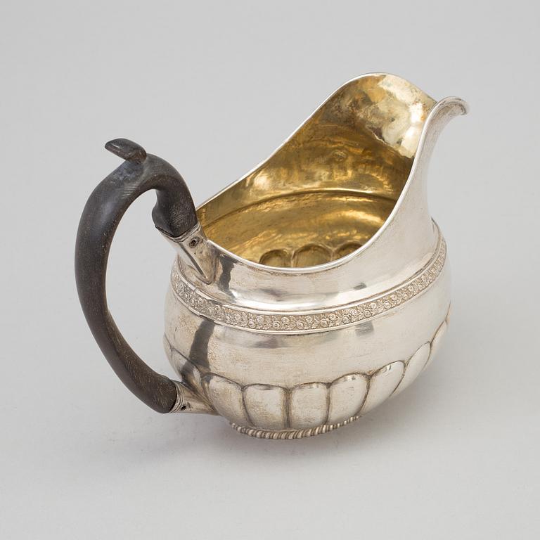 A Russian Empire parcel-gilt cream jug, maker's mark Elias Modig (1795-1834), St Petersburg, 1824.