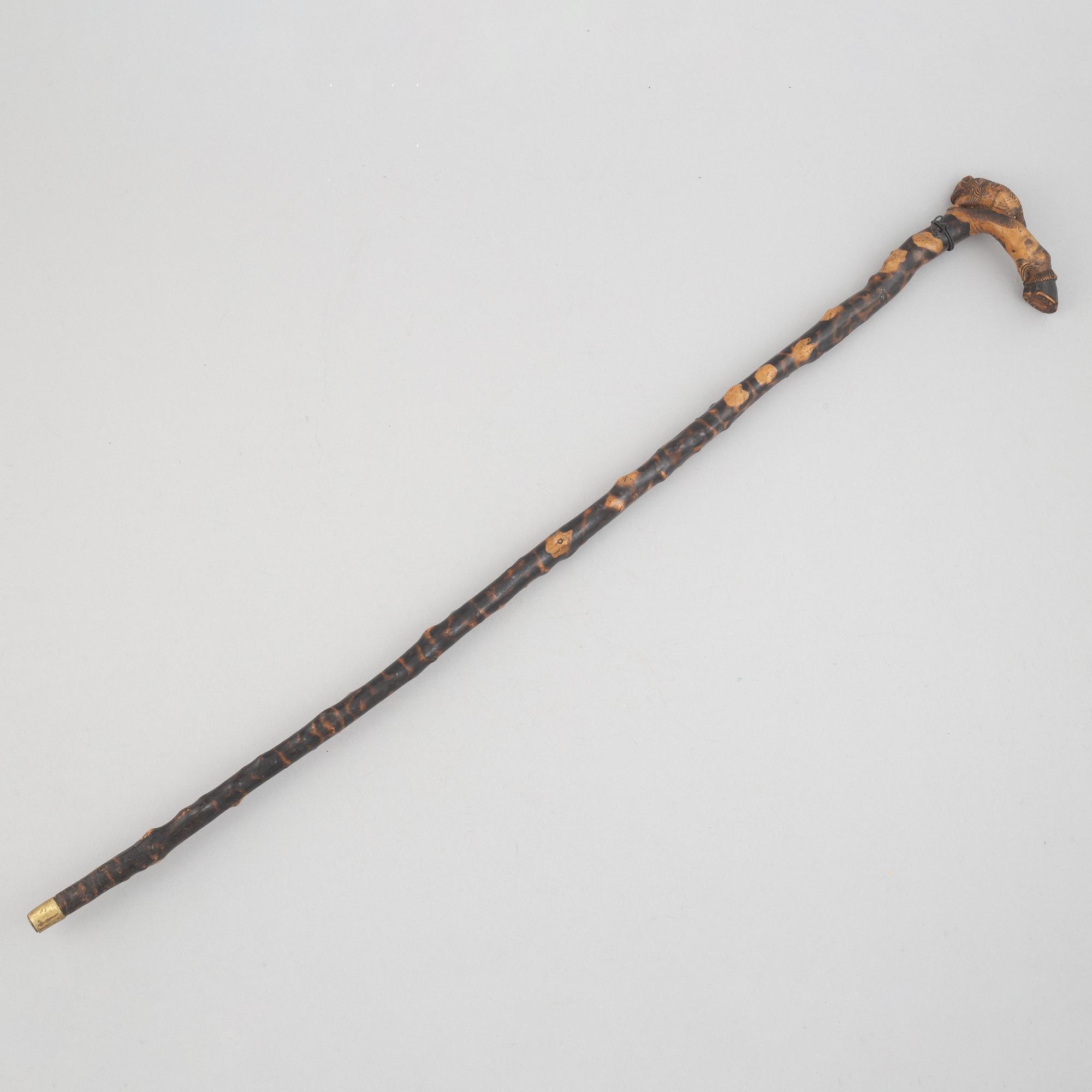 A carved wooden cane, 19th century.
